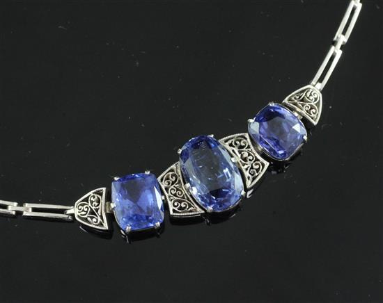 An early 20th century white metal and three stone sapphire bracelet,